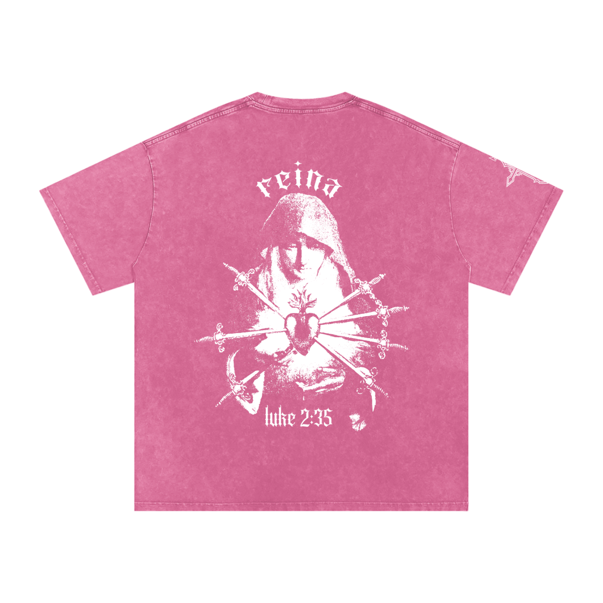 A pink short-sleeve t-shirt with a distressed white graphic on the back. The graphic features an image of the 7 sorrows of Mary with the word Reina above her head and 'Luke 2:35' below.